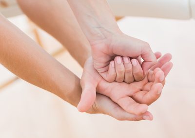 Physiotherapist doing hand massage in medical office